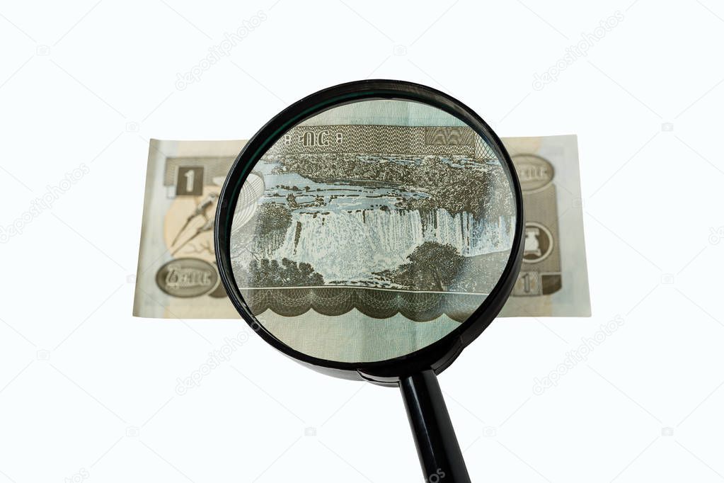 one Ethiopian birr bill and magnifying glass