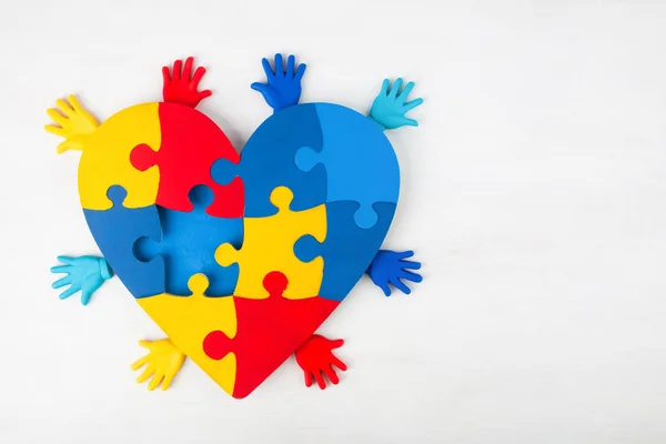 Puzzle heart hands support autism awareness — Stock Photo, Image