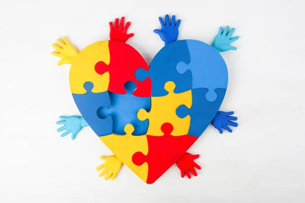 Puzzle heart hands support autism awareness — Stock Photo, Image