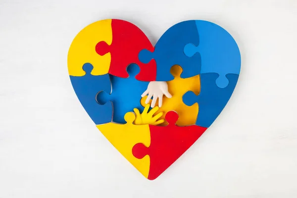 Puzzle heart hands support autism awareness — Stock Photo, Image