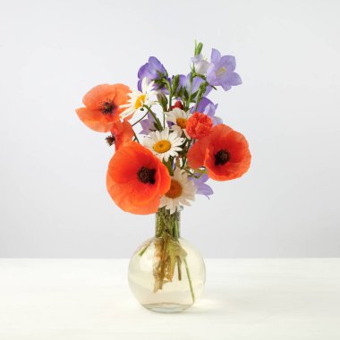 Bouquet of beautiful flowers Chamomiles wheat and poppies clipart