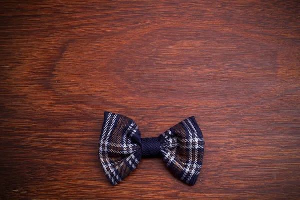 Bow tie on dark wooden background. Top view — Stock Photo, Image