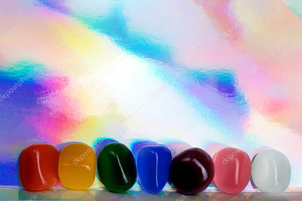 Chakra Healing Stones header rainbow coloured graduated banner copy space above. Top view