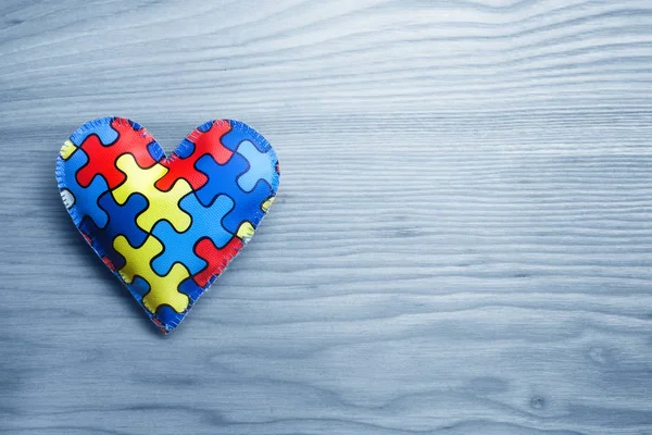 World Autism Awareness day, concetto di salute mentale con puzzle o modello di puzzle sul cuore — Foto Stock