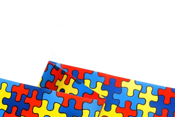 World Autism awareness and pride day with Puzzle pattern ribbon isolated on white — Stock Photo, Image