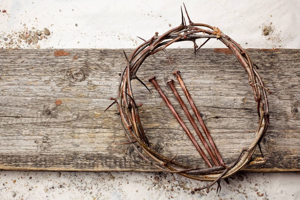 Jesus Crown Thorns and nails on Old and Grunge Wood Background. Vintage Retro Style.