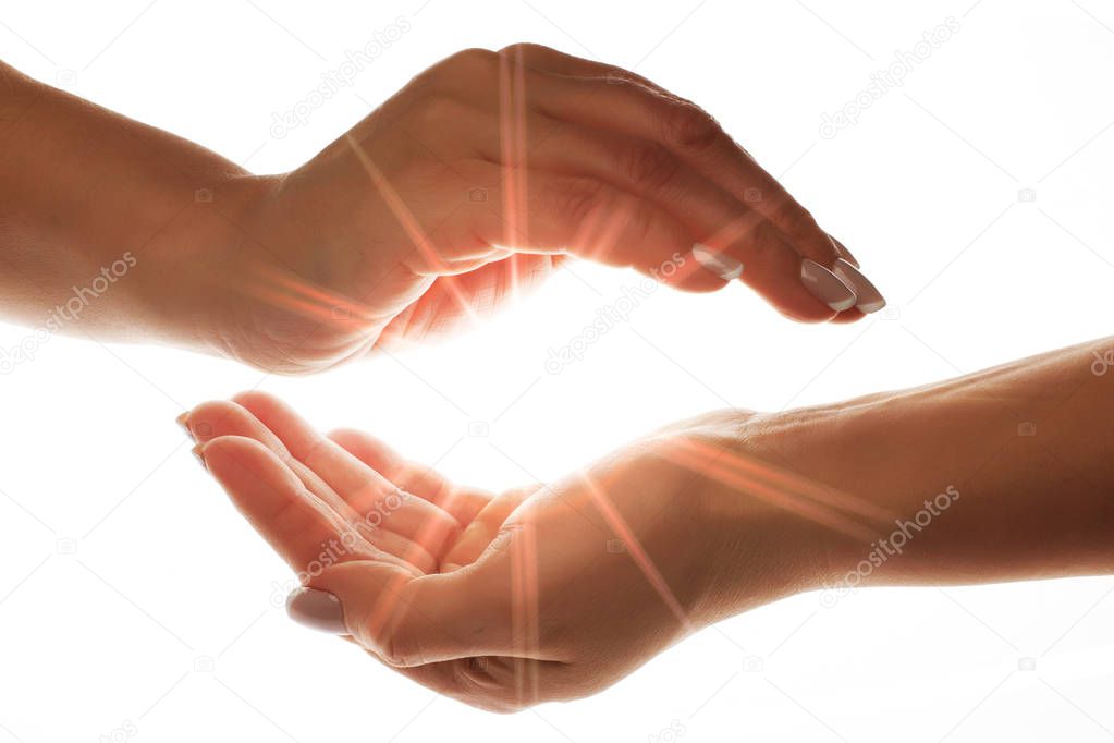 light in the hands isolated on white background