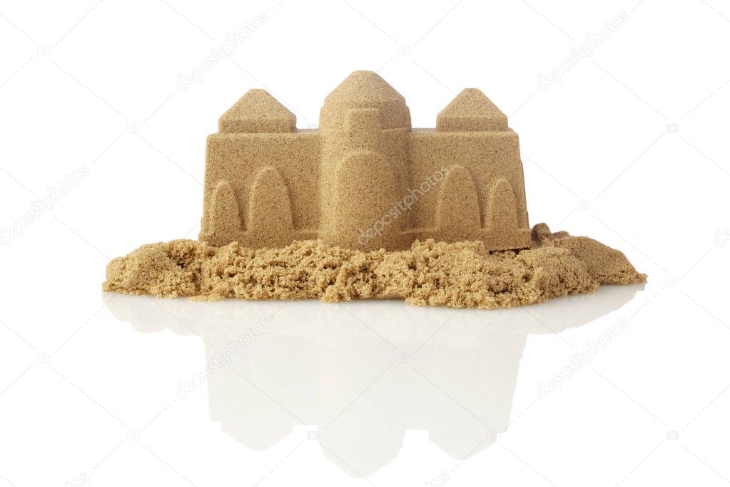 Sandcastle at the beach isolated on white background