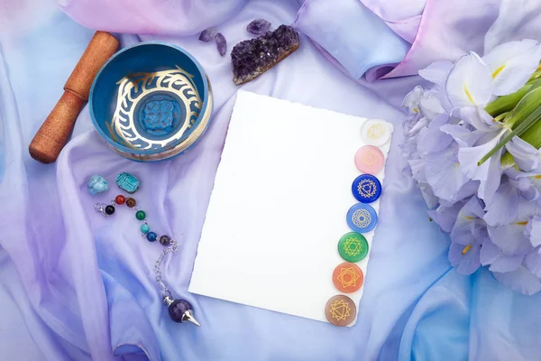 Cristalli naturali e pendolo su fondo in seta pastello. Sfondo Reiki con scheda vuota per testo — Foto Stock