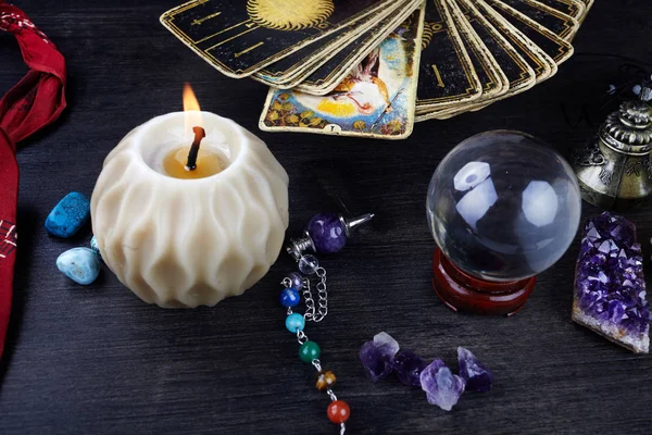 Still life with the tarot cards, magic stones and candles on wooden table. Fortune telling seance or magic ritual. — Stock Photo, Image