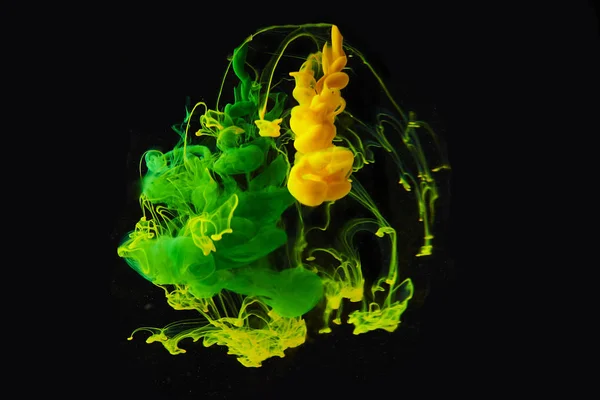 Studio shot of colored ink in water isolated on black background — Stock Photo, Image