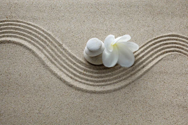 Spa concept. Flower and stones on sand — Stock Photo, Image