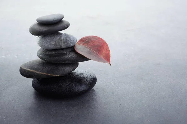Pietre zen in pila bilanciata su sfondo grigio scuro — Foto Stock