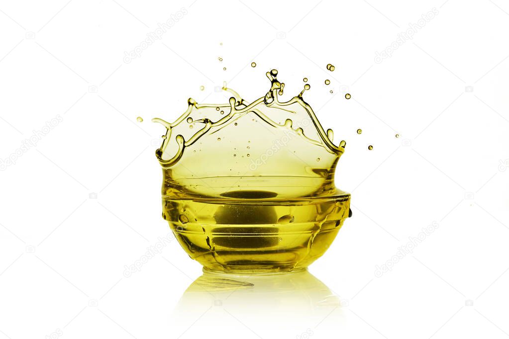 Olive oil in a glass bottle and green olives on white background, top view.
