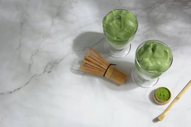 Green matcha dalgona. Trendy hipster drink on marble background. clipart