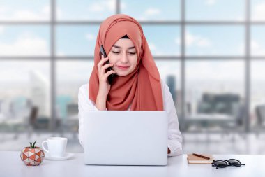 Müslüman kadın bilgisayar ile çalışmak, ofiste hijab Müslüman kız ve o cep telefonu konuşuyor, destek, iletişim veya müşteri hizmetleri kavramı fotoğraf