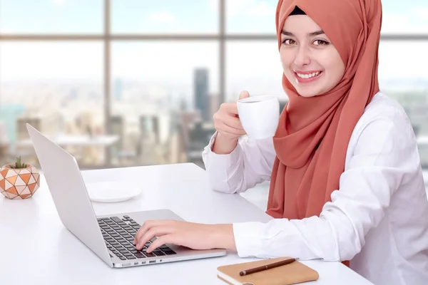 Muslim woman work with computer, hijab muslim girl at office