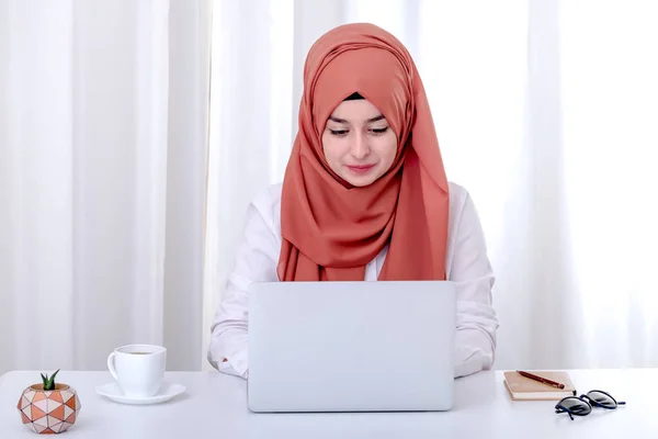 Muslim woman work with computer, hijab muslim girl at office