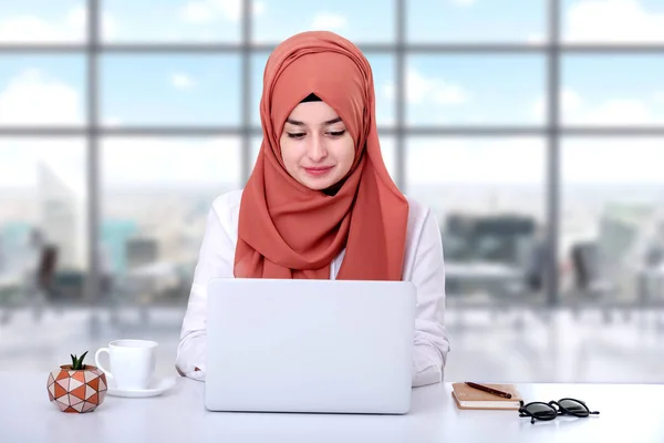 Muslim woman work with computer, hijab muslim girl at office, she is looking screen