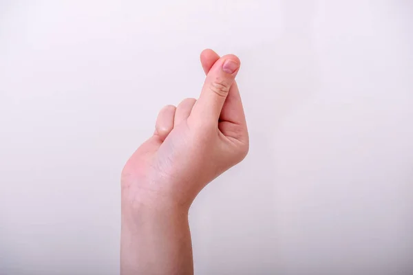 Korean symbol of love heart with woman fingers. A girl hand depicts a heart.