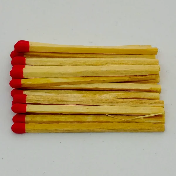 Close-up view on scattered safety matches on the white background.