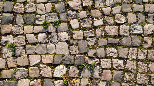Detail view on old medieval road made of cobblestones.
