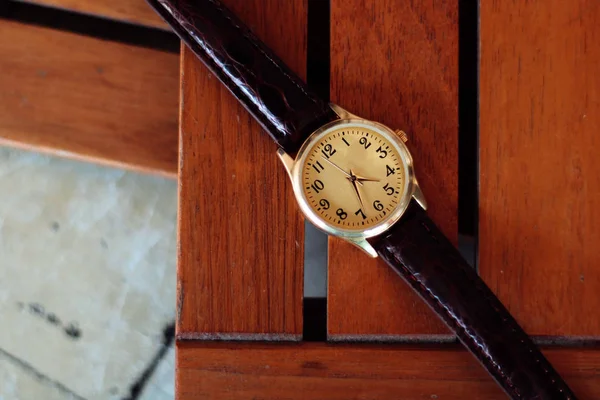 Quartz watch on a wooden background.