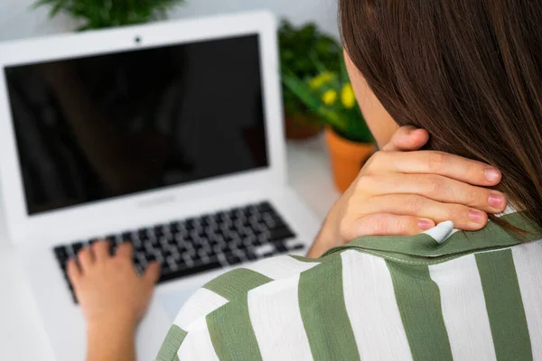 Office worker woman with neck pain. Neck pain concept at work. Ergonomics at work.