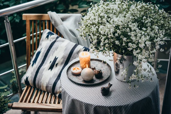 Beautiful terrace or balcony with small table, candles and flowers