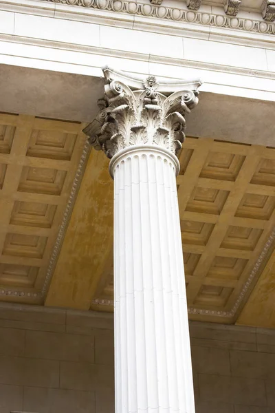 Beautiful white column in the Corinthian style, the decoration of column. The architecture of antiquity, the Greek ancient architectural tradition, the Corinthian order column