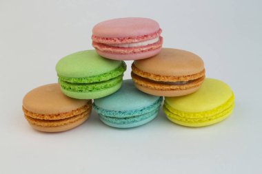 Macaruni multicolor standing pyramid on a white background. Cake, sweet pastry cookies