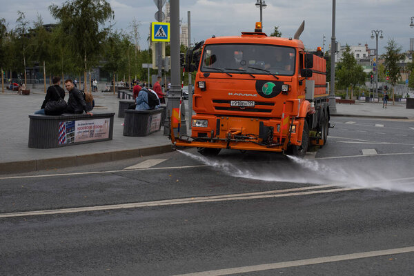 Moscow, Russia - August 24, 2020: Kamaz watering machine washing the street of the capital with shampoo and water.