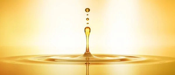 Goldener Tropfen aus Oel mit Spiegelung