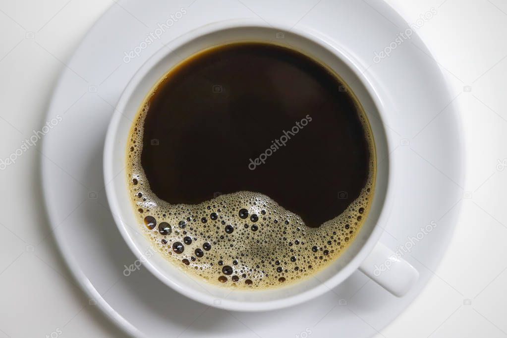 top view of cup with black coffee with bubbles