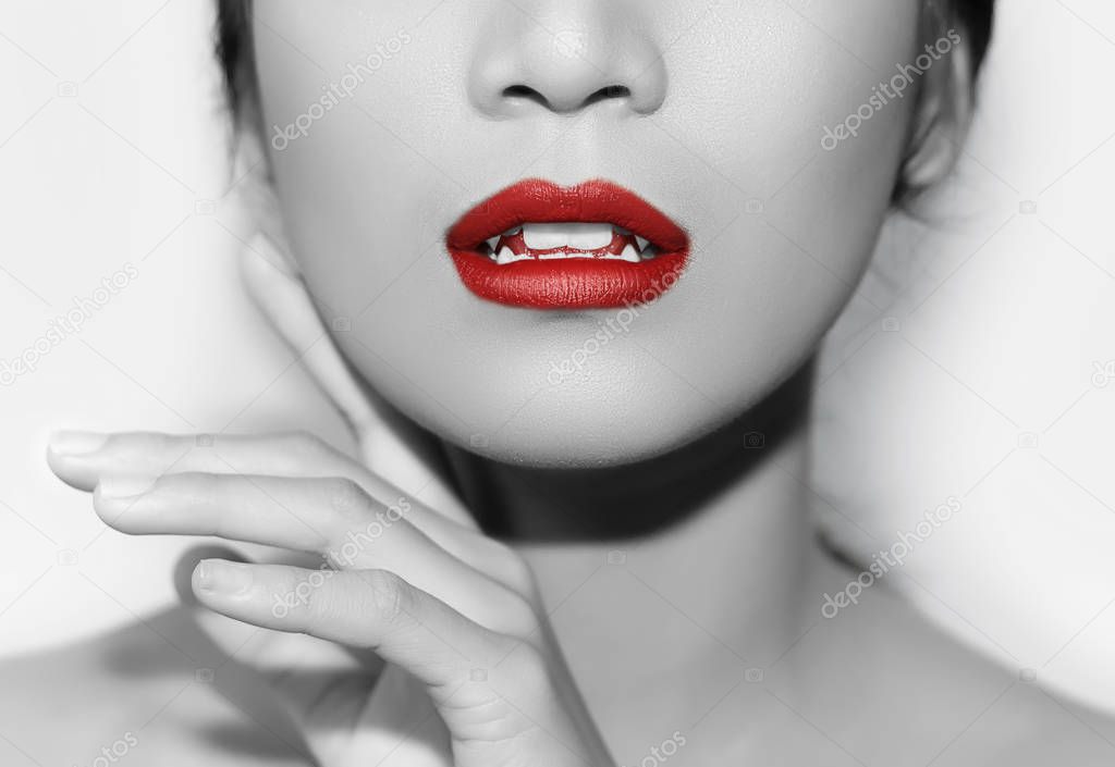 cropped shot of young woman with glossy skin and red lips, black and white