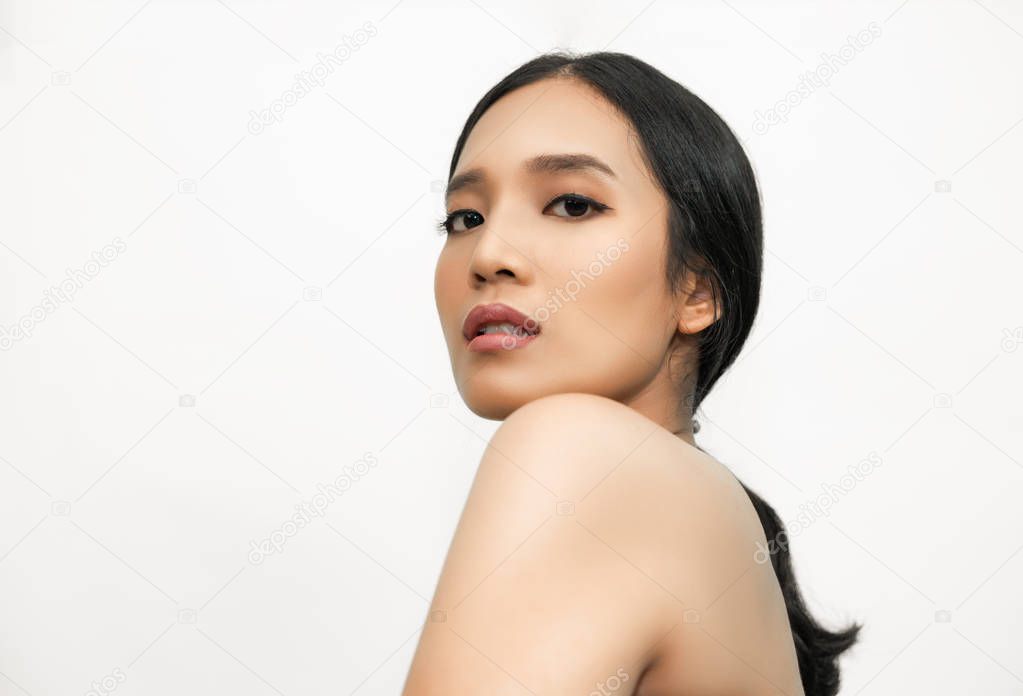 portrait of young asian woman with glossy skin on white background