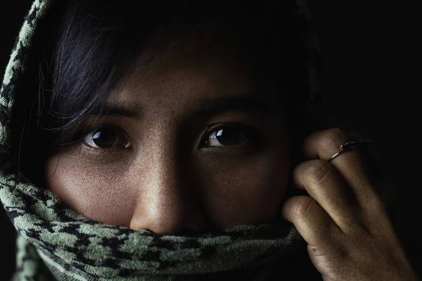 Close-up pictures of sad eyes and faces of Arab women There are freckles on the face and face covering fabric.