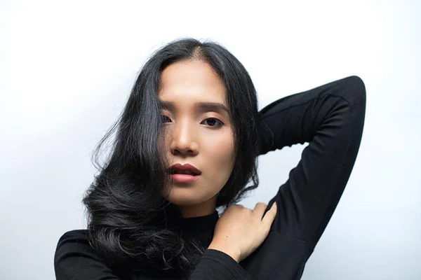 Woman with black curly hair Wearing a black turtleneck sweater Poses shooting on a white background