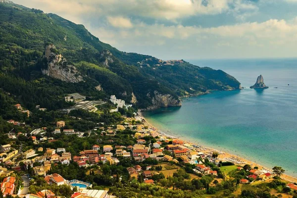 Beautiful beach and boats. Clean sea with a bay. Concept for travel, vacation and tourism. Great place for summer holidays and swimming.  Corfu island, Greece.