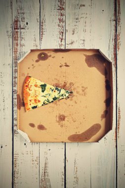 Ahşap bir arka plan üzerinde bir kutu içinde lezzetli taze pizza. Gıda konsepti - fast food - eve teslim.