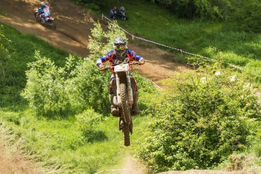 Lviv, Ukrayna - 20 Mayıs 2018: Motokros pistinde Açık Lviv Kupası. Bilinmeyen motosiklet yarışçısı, şampiyonluk maçında motokros pistinin üstesinden geldi..