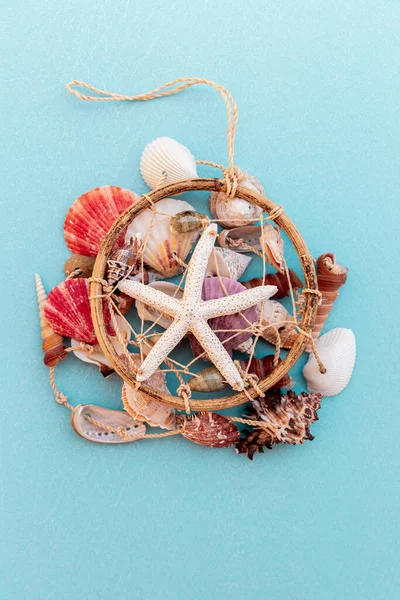 sea shell decoration. dream catcher on blue background