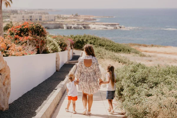 Family go to sea beach. Mother and her daughters on summer vacation. rest in Cyprus