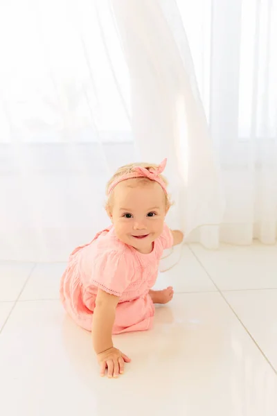 Niña cerca de la ventana jugando a las escondidas con cortinas — Foto de Stock