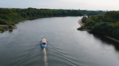 Tekne Oka nehrinde yüzüyor sonbahar akşamı, insanları nehirde taşıyor..