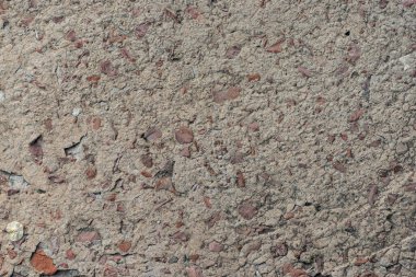 Beton duvar ve temel dokusu. Küçük çakıl taşları ve yontulmuş.