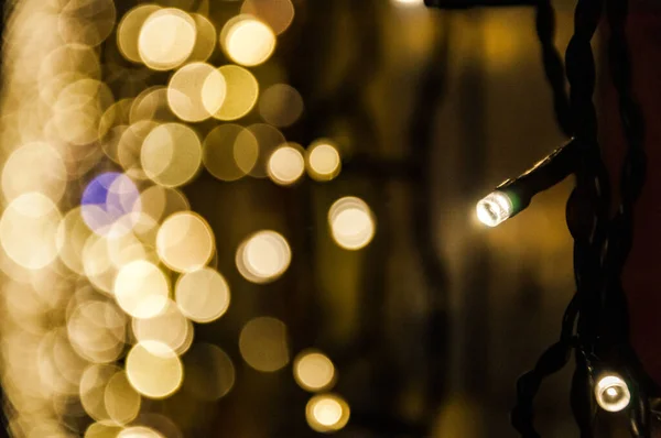 Christmas garlands glow in the dark bokeh in the background