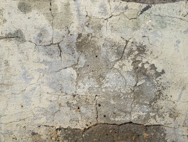 Beton duvar dokusunda bir sürü çatlak var.