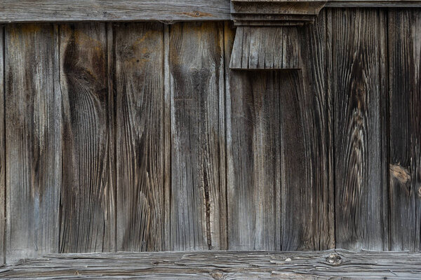 The texture of the old wooden fence dark color