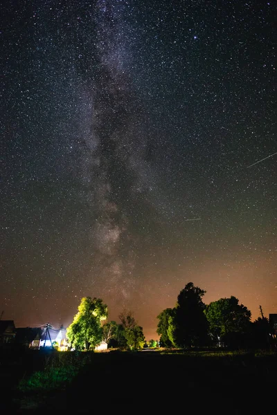 Starry sky with the milky way over the road in the countryside